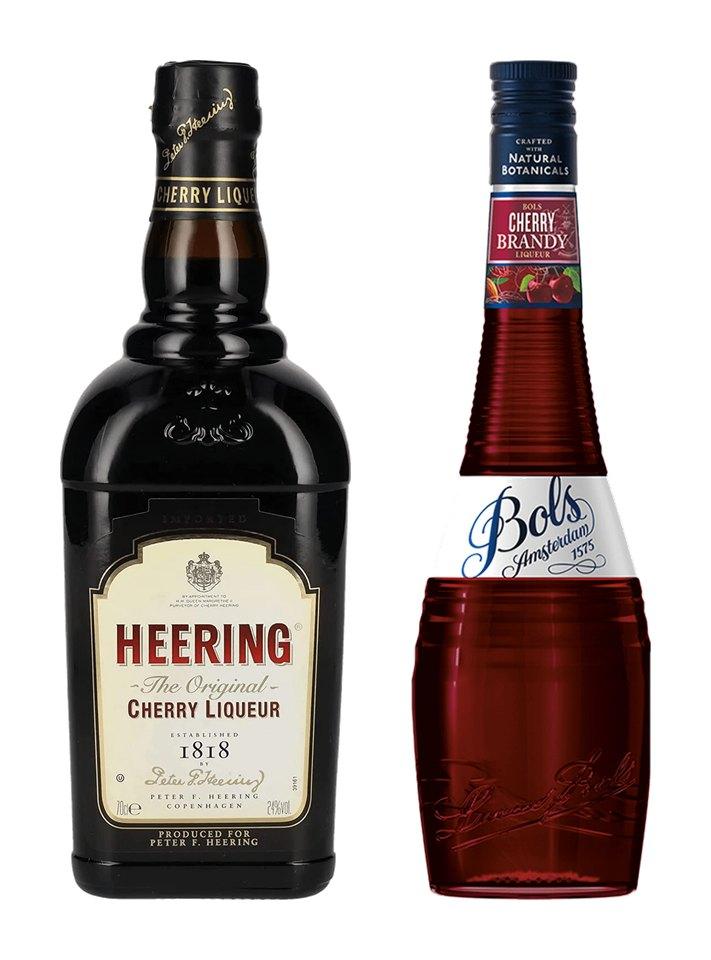 A bottle of Heering Cherry Liqueur and a bottle of Bols Cherry liqueur.