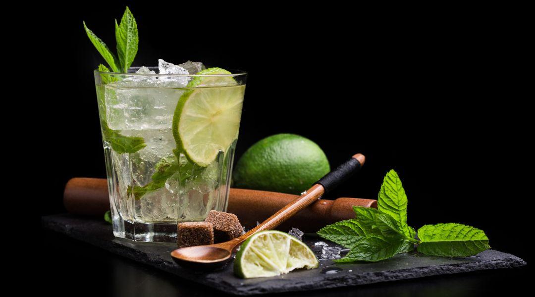 Ingrediencie na Mojito – biely rum, limety, mäta, trstinový cukor a sódová voda pripravené na stole | Svet nápojov